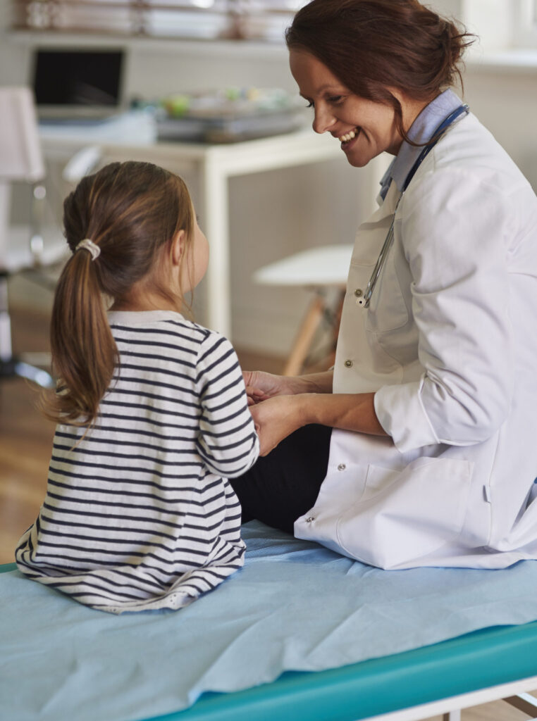Doctor checking a young girl.